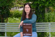 Archäologin Katharina Ramstetter mit ihrem Buch zur Römerstadt Teurnia